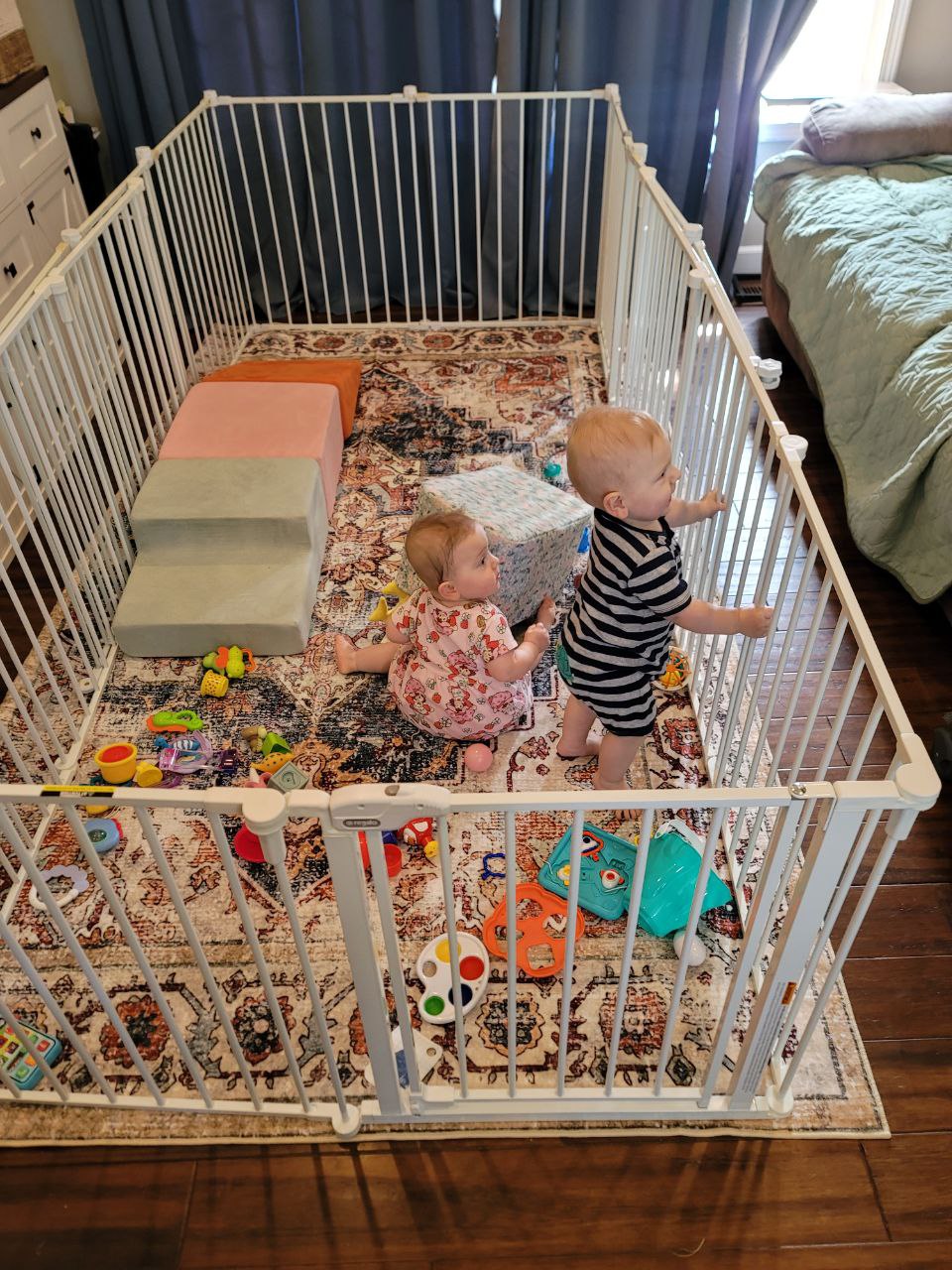 Twins playing in the new play pen